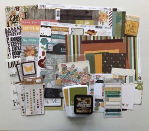 Scrapbooking supplies, cardstock, patterned paper, stickers, die-cuts, Ink pads, stencil to make a kit.