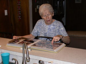 Grandma looking through scrapbook album; reference picture for Small Town Scrap home page